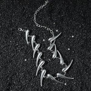 Irregular thorn geometric hip hop metal statement necklace on black stone background