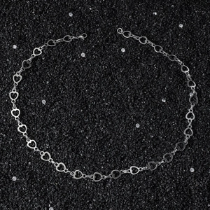 Collier hip hop en acier inoxydable avec maillons en cœur sur fond noir texturé