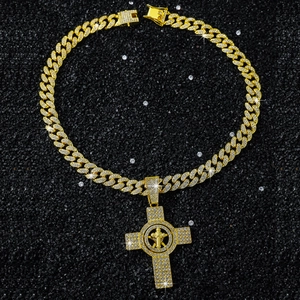 Close-up of gold plated Cuban chain necklace with a rotating iced-out cross pendant