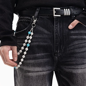 Détail d'une chaîne de pantalon hip-hop double couche avec boules de cristal sur un jean