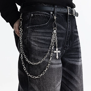 Double-layered silver pant chain with cross pendant on black denim jeans for street style
