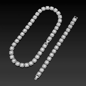 Detailed close-up of hip-hop style silver tennis chain necklace and bracelet set with square stones