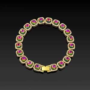Detailed macro of gold plated bracelet with square colored stones and diamond accents