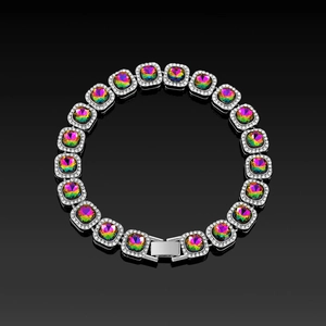 Macro shot of silver hip-hop tennis bracelet with rainbow gemstones and CZ pavé