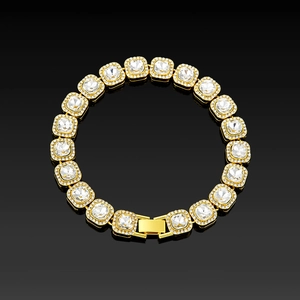 Detailed close-up of a gold square-cut crystal tennis bracelet on black mirror background