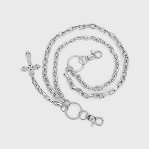 Close-up of double-layered silver trousers chain with vintage cross pendant and lobster clasp