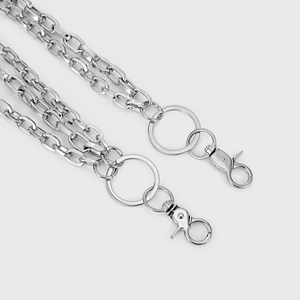 Detail view of double-layered silver metal pants chain with sturdy lobster clasps