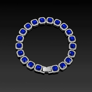 Detail of cushion-cut blue crystal bracelet with silver halo setting on black surface