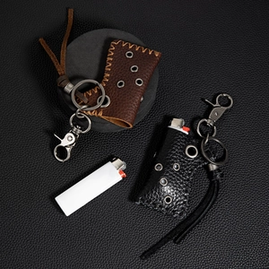 Close-up of vintage cowhide leather lighter case with metallic eyelets and sturdy key ring