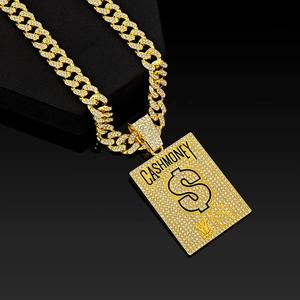 Close-up of golden hip-hop Cuban necklace with iced out Cash Money dollar sign pendant