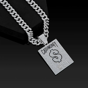 Macro shot of silver hip-hop Cuban link necklace with iced out Cash Money dollar pendant
