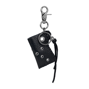 Detail of black pebbled leather lighter case with industrial metal eyelets and steel hook