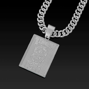 Macro shot of silver hip hop Cuban chain necklace with CASH MONEY dollar sign pendant