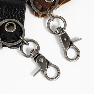 Detail of vintage metal lobster clasp and premium leather straps for biker keychain
