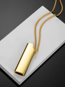Macro shot of mirror-polished gold lighter case pendant with an elegant wheat chain