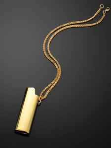Macro detail of high-polish gold lighter pendant with durable wheat chain necklace