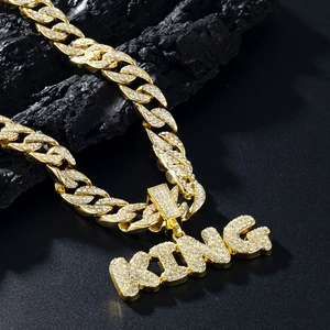 Iced out gold Cuban link chain with large KING letter pendant in hip-hop style