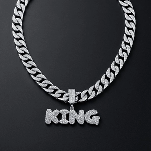 Silver iced-out Cuban chain necklace with a rhinestone-studded KING letter pendant