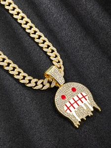 Macro detail of iced-out hip hop ghost pendant with red eyes on gold Cuban chain