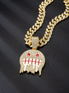 Detail of hip hop Cuban link chain with iced out crystal pendant on black silk fabric