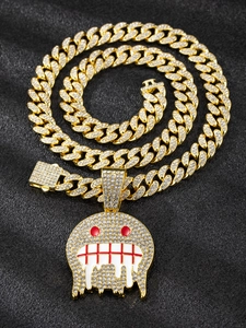 Macro detail of gold Cuban chain necklace with iced-out dripping cartoon pendant