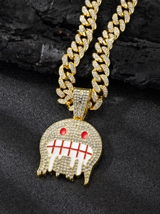 Detailed macro of gold-plated hip hop pendant with cubic zirconia on a Cuban link chain