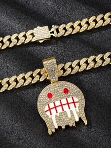Detail of hip hop gold Cuban link chain with a diamond encrusted fluid monster pendant