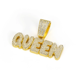 Macro detail of gold plated QUEEN letter pendant with paved rhinestones on bail