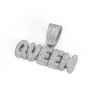 Detailed macro view of iced out QUEEN letter pendant with full crystal pavé and bail