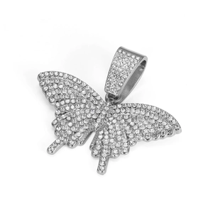 Macro detail of silver tone butterfly pendant with pavé set sparkling crystal stones