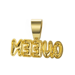 Macro detail of golden QUEEN bubble letter pendant with polished bail and crystal setting