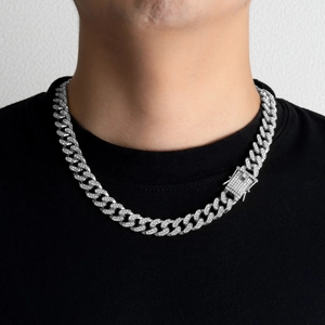 Close-up of 13mm silver Cuban link necklace with iced out rhinestones on black shirt