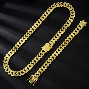 Detailed macro view of 13mm gold cuban link chain with full diamond pavé settings