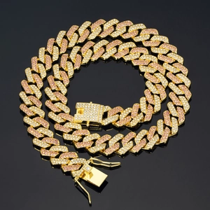 Detailed close-up of pink and white rhinestones on a gold hip hop Cuban link chain
