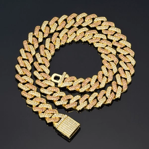 Macro view of gold-plated hip-hop Cuban link chain with pink and white rhinestones