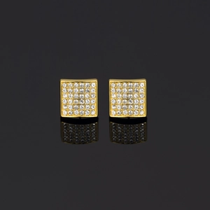 Macro shot of gold square stud earrings with pave-set shimmering zircon stones on black background