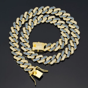 Detail of chunky gold Cuban link chain with blue and white pavé rhinestones box clasp