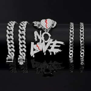 Macro shot of iced-out Cuban chain links and NO LOVE heart pendant with red stones