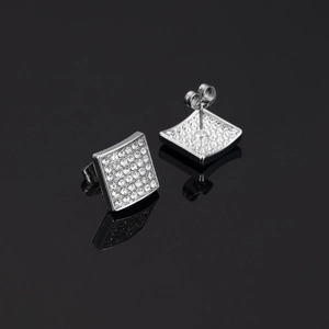 Detailed view of square silver stud earrings with sparkling rhinestones on black background