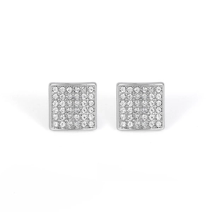 Macro shot of square hip hop earrings with white crystals in polished silver-tone metal