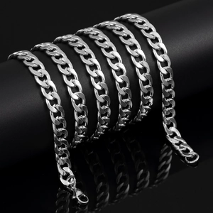 Detail of silver 7mm curb chain with lobster clasp on a black display cylinder