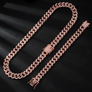 Close-up of rose gold Cuban link necklace set with micro-paved rhinestones on black background