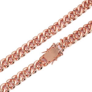 Macro view of rose gold Cuban link chain with detailed textured safety clasp closure