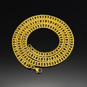 Detailed close-up of 8mm gold Cuban link chain with secure lobster clasp on black background