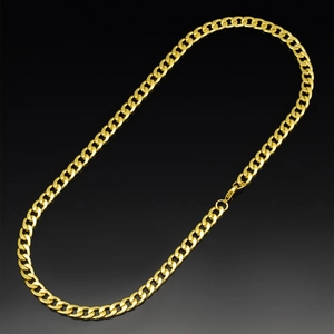 Close-up of 7mm gold-plated Cuban link chain with lobster clasp on reflective black surface