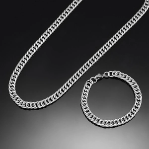 Polished silver 8mm curb chain necklace and bracelet set displayed on a reflective surface