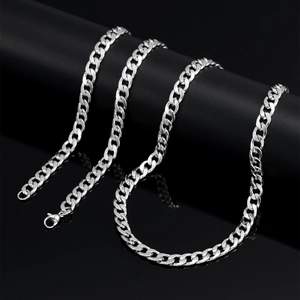 Detail of silver-toned 7mm curb chain with lobster clasp on professional black display