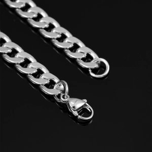 Macro shot of polished silver Cuban link chain detail with durable lobster clasp