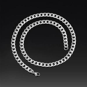 Detailed view of polished silver cuban link chain with lobster clasp on a black background