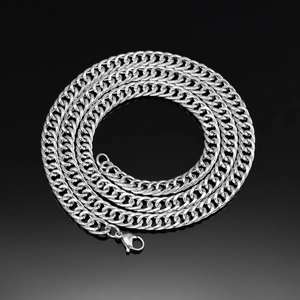 Detailed close-up of heavy silver-toned curb chain necklace with secure lobster clasp closure